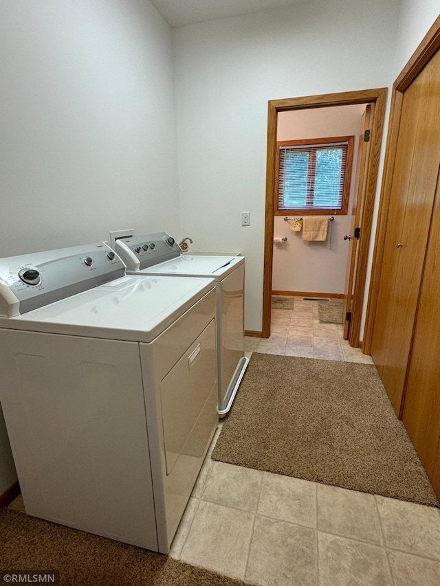 washroom with independent washer and dryer and light tile patterned flooring