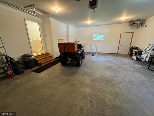 garage with a garage door opener and washer / clothes dryer