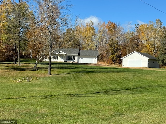 view of yard featuring an outbuilding and a garage