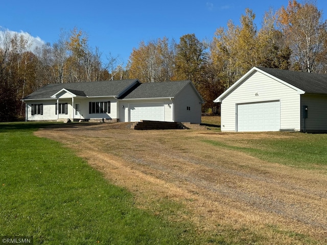 ranch-style home with a garage and a front lawn