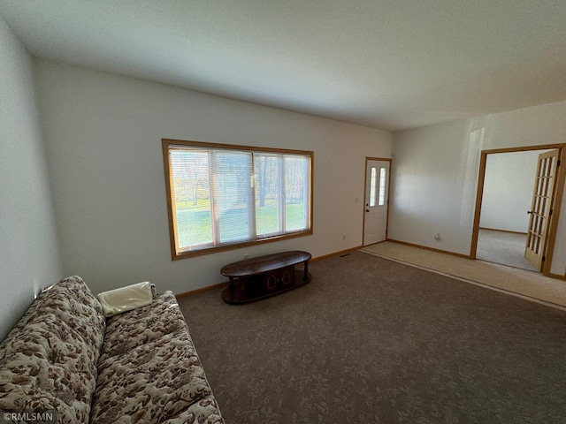 unfurnished living room featuring carpet flooring