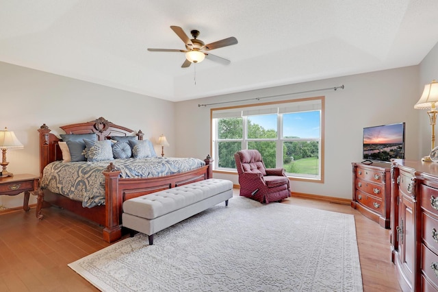 bedroom with ceiling fan and light hardwood / wood-style flooring