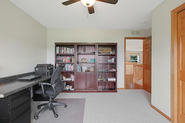 office with light carpet, ceiling fan, and a textured ceiling