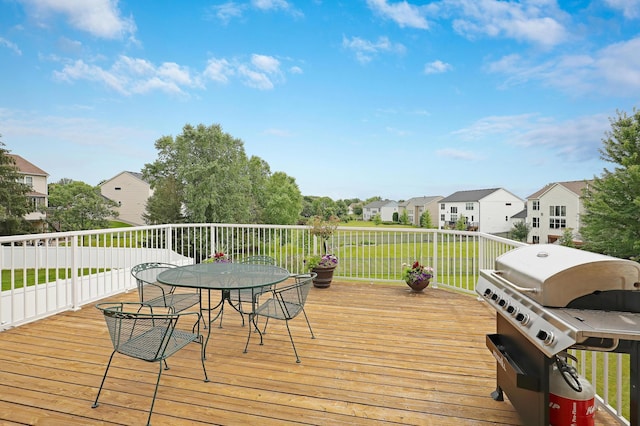 deck with a lawn and grilling area