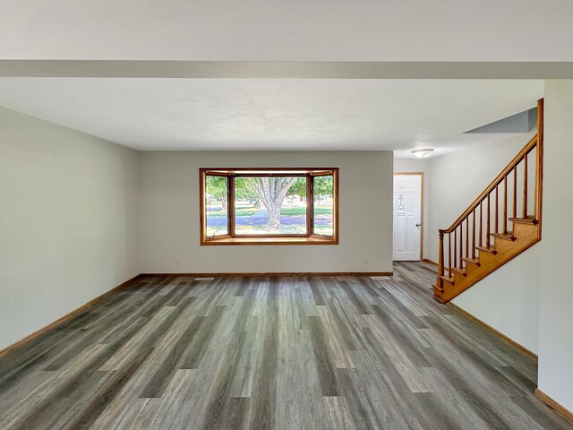 unfurnished living room featuring wood-type flooring