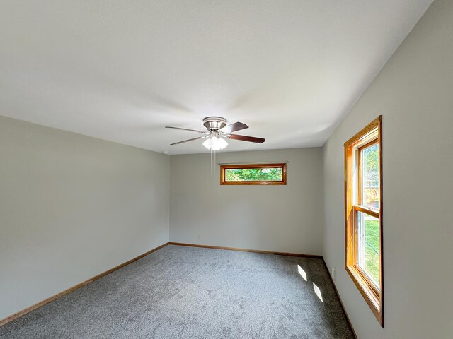 carpeted empty room featuring ceiling fan