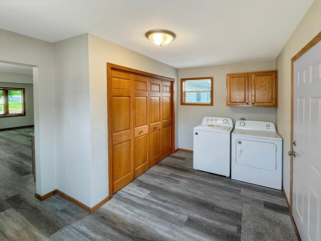 washroom featuring cabinets, independent washer and dryer, and dark hardwood / wood-style floors