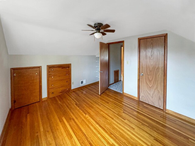 additional living space featuring light hardwood / wood-style floors, vaulted ceiling, and ceiling fan