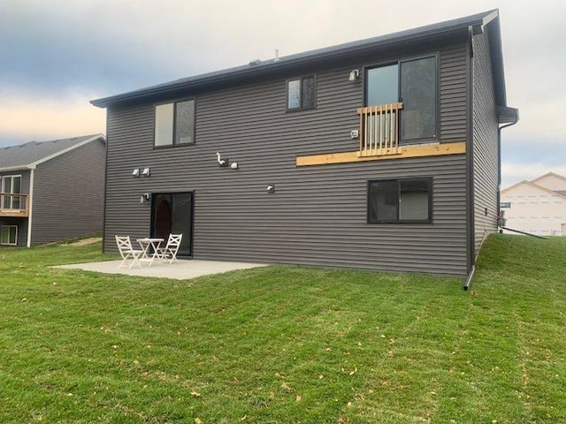 back of house with a yard and a patio