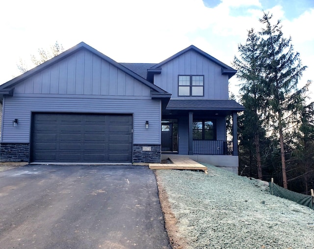 view of front of home with covered porch and a garage