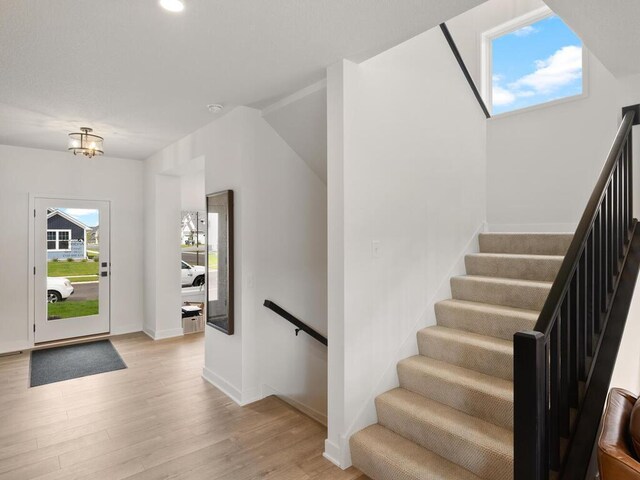 foyer entrance featuring light wood-style flooring, baseboards, and recessed lighting