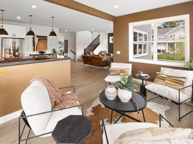 living room featuring light wood-type flooring, stairway, recessed lighting, and baseboards
