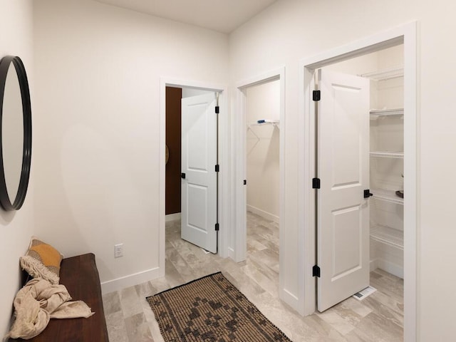 corridor featuring baseboards