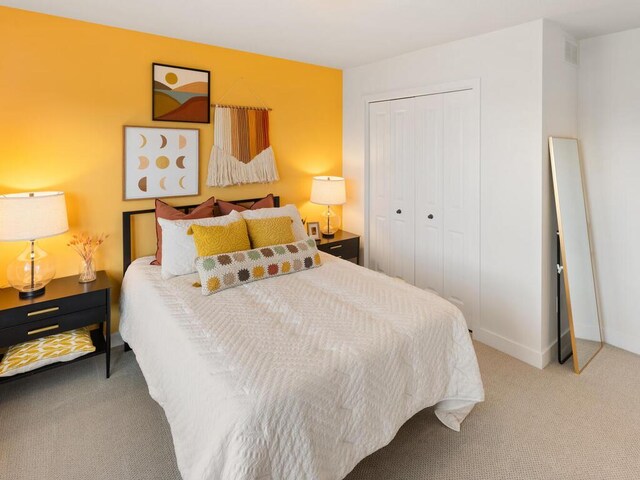 bedroom with carpet floors, a closet, and baseboards