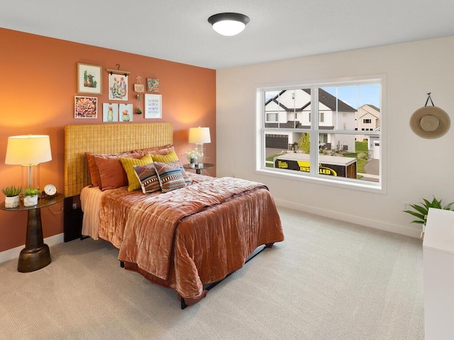 carpeted bedroom featuring baseboards