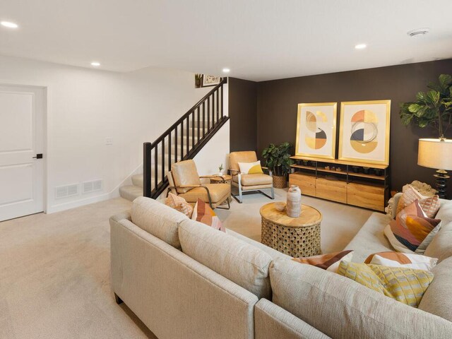 living room with stairs, recessed lighting, and carpet flooring