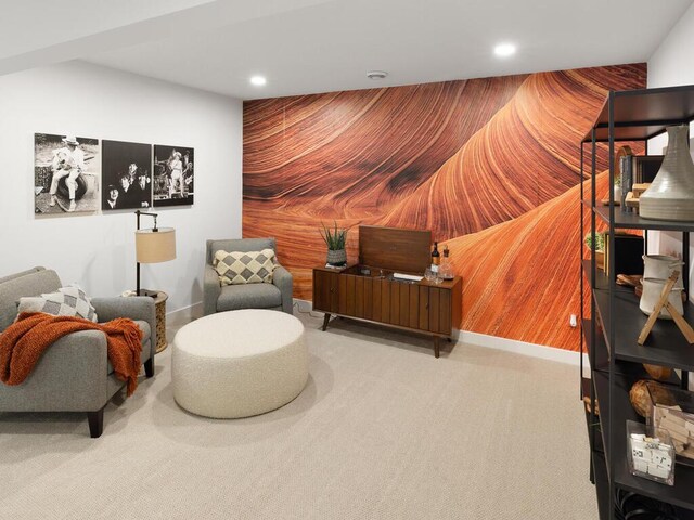 sitting room featuring carpet, recessed lighting, and wood walls