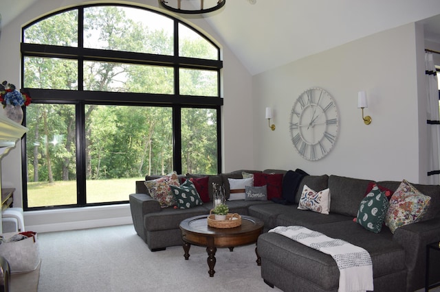 living room featuring carpet, lofted ceiling, and a chandelier