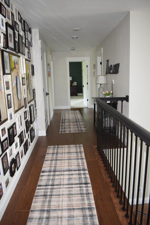 corridor with dark hardwood / wood-style flooring