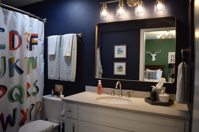 bathroom with vanity, toilet, and walk in shower