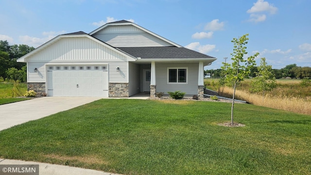 craftsman-style house with a garage and a front lawn