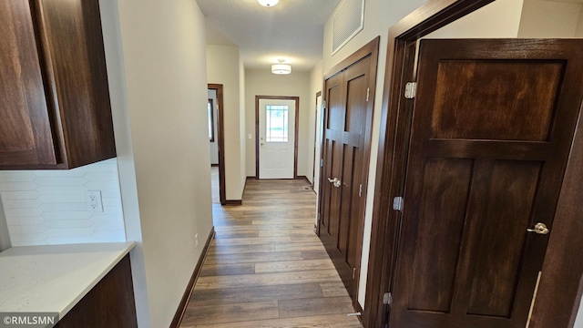 corridor with wood-type flooring