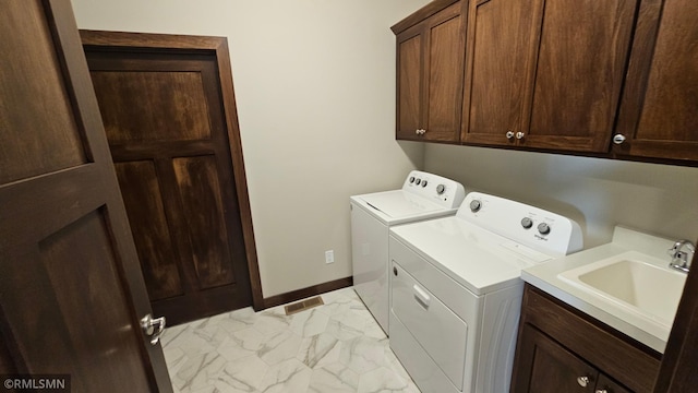 washroom with sink, cabinets, independent washer and dryer, and light tile patterned floors