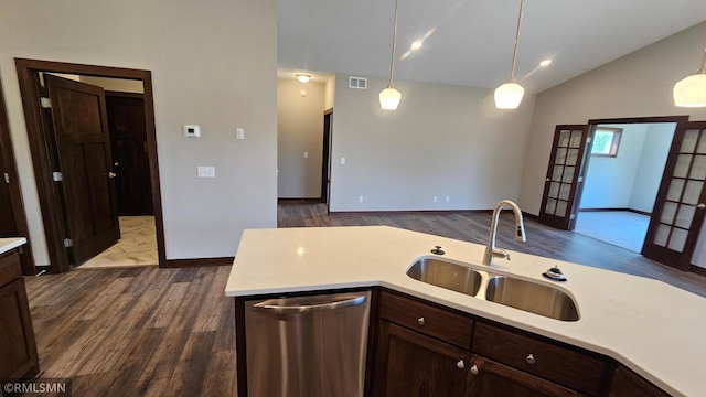 kitchen featuring stainless steel dishwasher, sink, pendant lighting, and hardwood / wood-style flooring