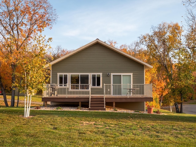 view of front of home with a wooden deck and a front yard