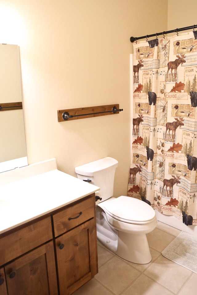 bathroom with tile patterned floors, vanity, and toilet