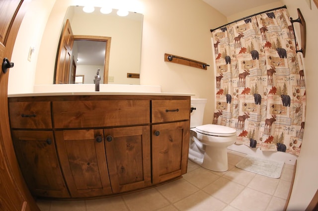 bathroom with vanity, toilet, and tile patterned floors