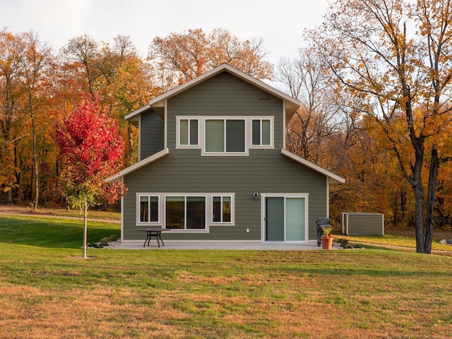 back of house with a yard and a patio area