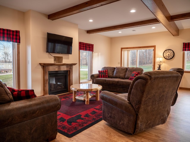 living room with light wood-type flooring and beam ceiling