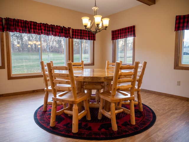 dining space featuring light hardwood / wood-style flooring and an inviting chandelier