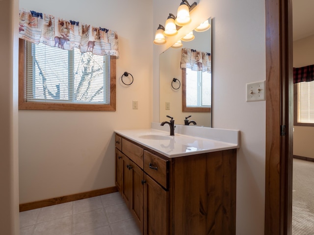 bathroom with tile patterned flooring, vanity, and plenty of natural light