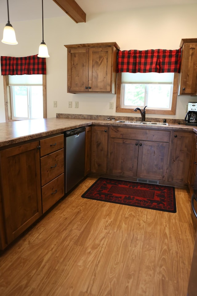 kitchen with stainless steel dishwasher, decorative light fixtures, beamed ceiling, sink, and light hardwood / wood-style floors