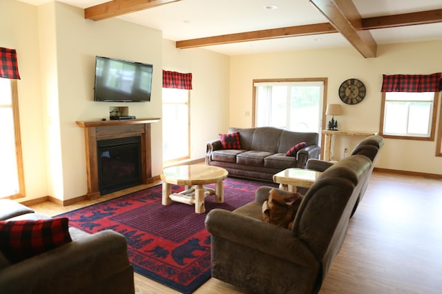 living room featuring light hardwood / wood-style floors and beamed ceiling