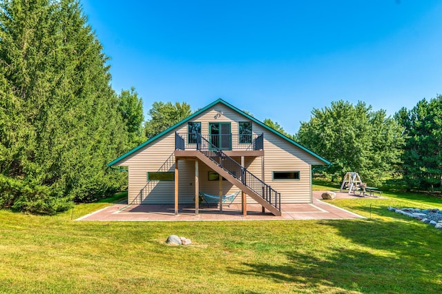 back of property featuring stairway, a patio, a lawn, and a deck