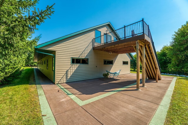 rear view of property featuring a yard, stairs, and a deck