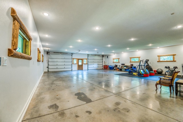 garage with recessed lighting and baseboards