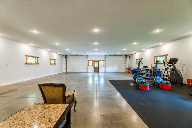 garage featuring recessed lighting and baseboards