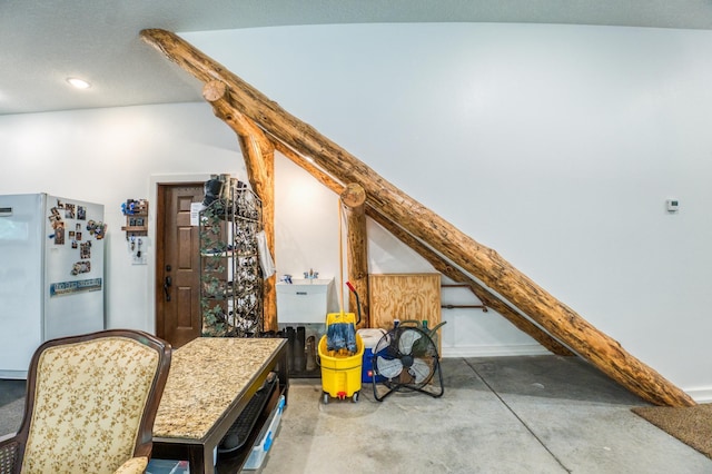 interior space featuring recessed lighting, concrete floors, freestanding refrigerator, and a sink