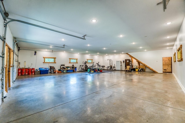 garage featuring recessed lighting and baseboards