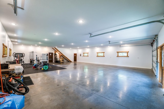 garage with recessed lighting and baseboards