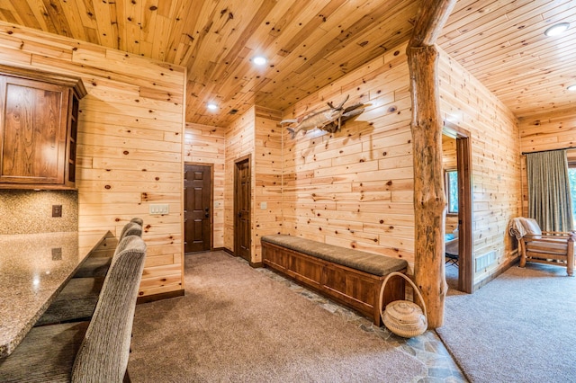 carpeted bedroom with wooden walls, recessed lighting, and wood ceiling