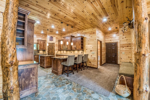 interior space with wooden walls, recessed lighting, stone finish flooring, wooden ceiling, and dark carpet