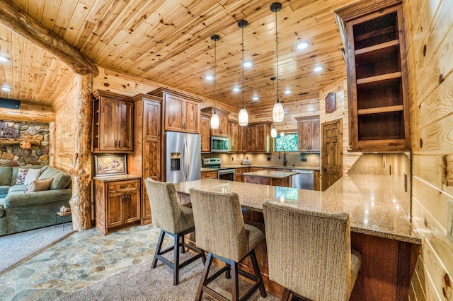 kitchen featuring wooden ceiling, stone finish floor, light stone counters, and appliances with stainless steel finishes