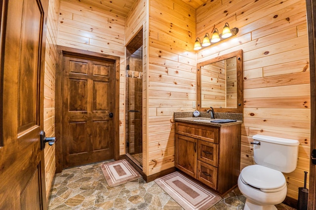 bathroom featuring wooden walls, toilet, a stall shower, and stone finish flooring