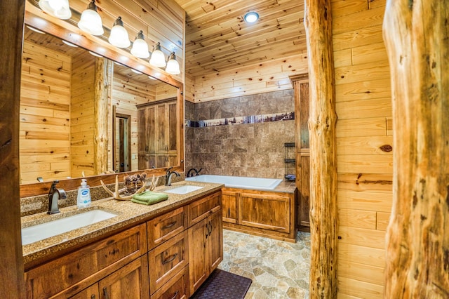 bathroom featuring stone finish floor, wood walls, a garden tub, and a sink