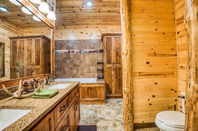 full bath featuring a shower stall, wood walls, toilet, a garden tub, and a sink